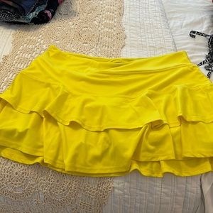 Bright yellow tiered tennis skirt.